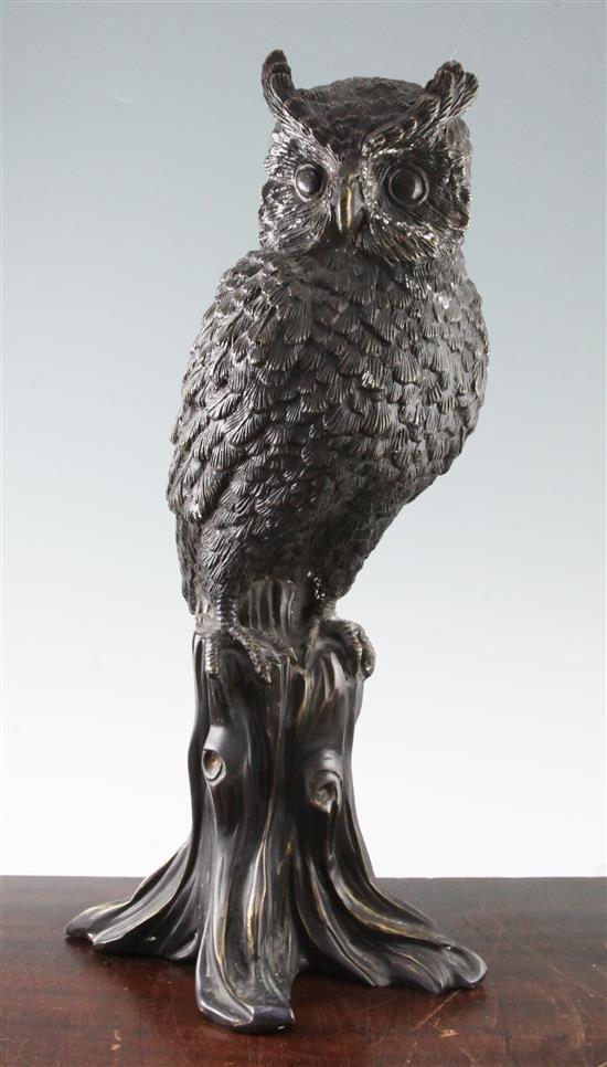 A modern bronze model of an owl perched upon a tree stump, 24in.